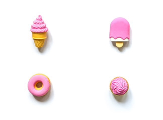 Different toy sweets in miniature with soft shadows close-up isolated on a white background.