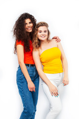 Fototapeta premium young pretty teenage girls friends with blond and brunette curly hairs posing cheerful isolated on white background, lifestyle people concept