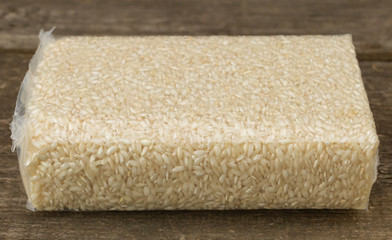 Fototapeta na wymiar Rice benefits and properties concept, Dry rice on wooden background