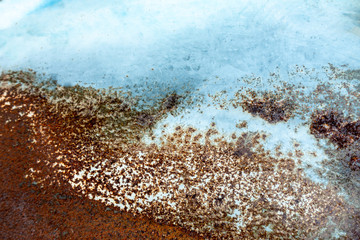 Old grunge vintage background: rusty metal surface with blue paint flaking and cracking texture