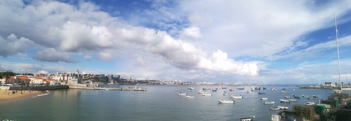 panorama of Cascais Bay with blue sky and white clouds