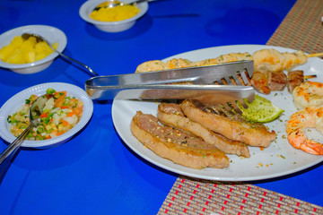 Typical brazilian dish with meat, shrimps, skewer, yucca and cassava, Porto Seguro, Bahia, Brazil