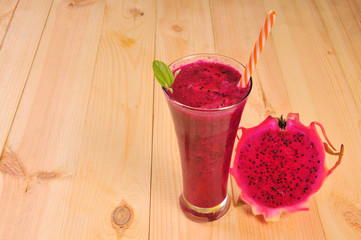 Red dragon fruit smoothies in glasses with half sliced. Pitahaya fruit. Dragon Fruit Juice. Half sliced dragon fruit.