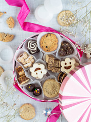 Fototapeta na wymiar Festive pink box with variety of small cookies inside