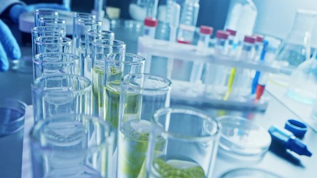 Pharmaceutics Laboratory: Multiple Pipettes Dropping Yellow Liquid into Test Tubes, Medical Research and Analysis. Product Line; Dropper Fills Sample Tubes for DNA Study. Close-up Macro
