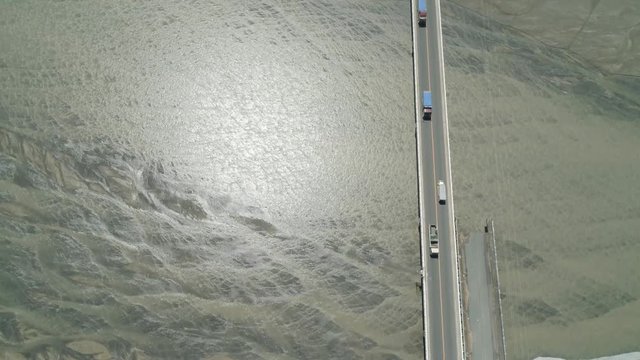 Modern bridge over river with cars in a mountain province Philippines,Luzon. Aerial view Bucao Bridge.