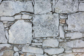 Irregularly shaped stone block wall.