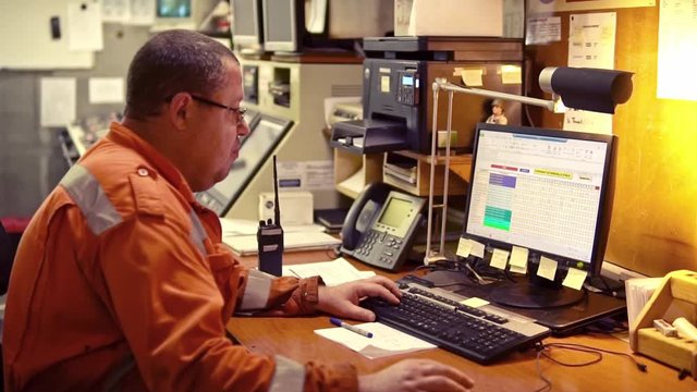 Marine engineer officer in engine control room ECR. Seamen's work. He works on the computer