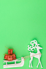 Toy deer with a sleigh carries gifts