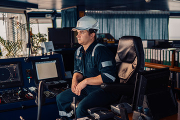 Marine navigational officer during navigational watch on Bridge . Work at sea