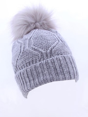 Beautiful luxury knitted hat with a gray fur on a white background