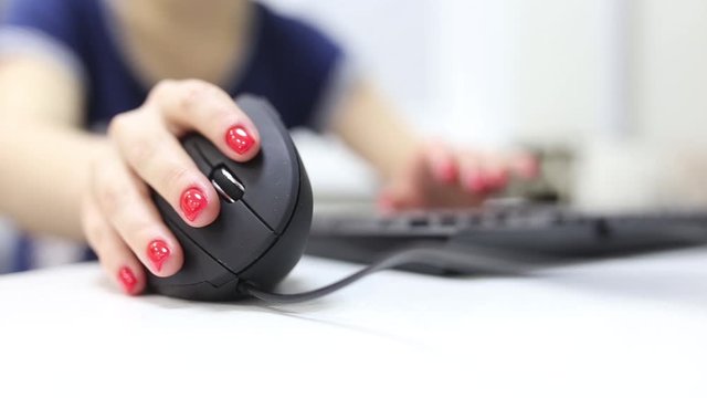 girl's hand uses a vertical ergonomic computer mouse joystick.