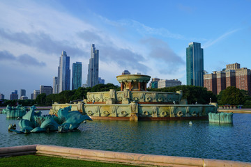 View of Buckingham Fountain, while fountain is turned off, centered with Chicago, IL buildings in background