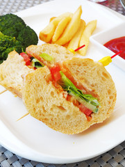 Vegetable sandwich with  french fries and ketchup on white plate