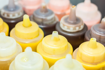 close up photograph of mustard and bbq sauces