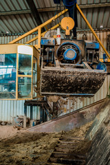 Plant for the production of bricks from clay. Plant for production building material with ready brick, construction industrial. Production of bricks on plant. Workflow, close-up. Many bricks