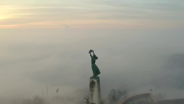12.17. 2019. budapest, Hungary. Moody foggy morning with liberty statue Winter. Rising sun. fog. mist. Liberty bridge. Bad weather