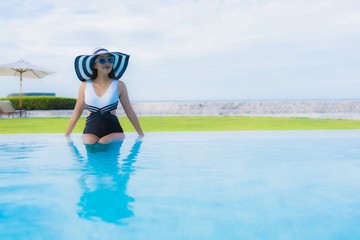 Portrait beautiful young asian women happy smile relax around swimming pool