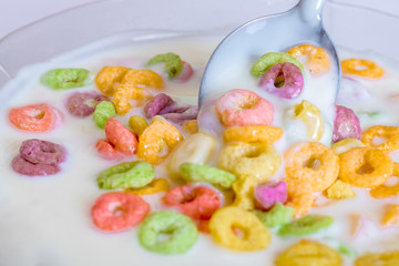 yogurt with cereals on white background and spoon