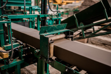 Plant for the production of bricks from clay. Plant for production building material with ready brick, construction industrial. Production of bricks on plant. Workflow, close-up. Many raw bricks