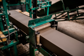 Plant for the production of bricks from clay. Plant for production building material with ready brick, construction industrial. Production of bricks on plant. Workflow, close-up. Many raw bricks