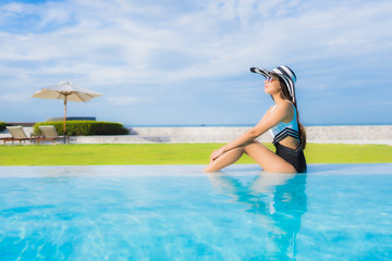 Portrait beautiful young asian women happy smile relax around swimming pool