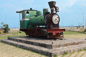 Fototapeta na wymiar Unused old rusty antique green steam train locomotive