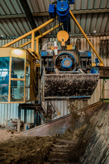 Plant for the production of bricks from clay. Plant for production building material with ready brick, construction industrial. Production of bricks on plant. Workflow, close-up. Many bricks