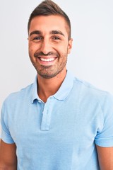 Fototapeta premium Young handsome elegant man wearing blue t-shirt over isolated background with a happy face standing and smiling with a confident smile showing teeth
