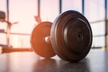 Fitness room with dumbbell and exercise equipment in the morning