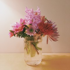 bouquet of flowers in vase on wooden table