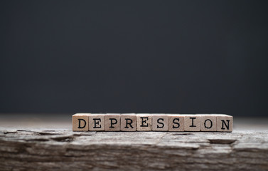 The word depression on a wood background and dark background - obrazy, fototapety, plakaty