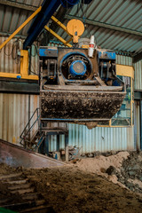 Plant for the production of bricks from clay. Plant for production building material with ready brick, construction industrial. Production of bricks on plant. Workflow, close-up. Many bricks