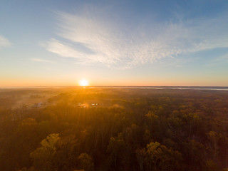Fototapeta na wymiar Colorful Sunrise over Forest and Countryside. Aerial Drone View
