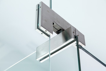 glass door hinges gray color, close up of hinged accessories of transparent partitions.