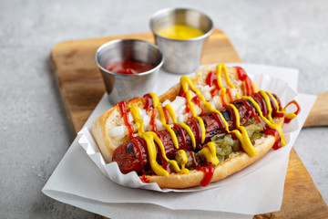 Classic american beef hot dog topped with ketchup, mustard, relish and onion