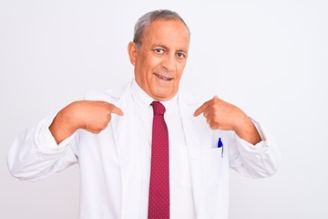 Senior grey-haired scientist man wearing coat standing over isolated white background looking confident with smile on face, pointing oneself with fingers proud and happy.