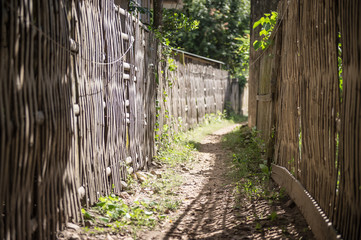 Footpath and old wooden fence in country side in Thailand