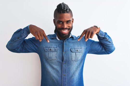 African american man with braids wearing denim shirt over isolated white background looking confident with smile on face, pointing oneself with fingers proud and happy.