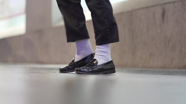 Close-up feet dancing with white socks and black shoe