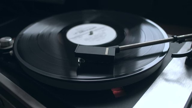 Old vintage good looking turntable playing a track with vinyl. 4k Uhd. Cinematic footage.