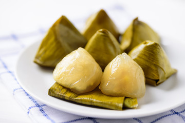 Thai dessert (Khanom Tian), sweet stuffed dough pyramid wrapped by banana leaf