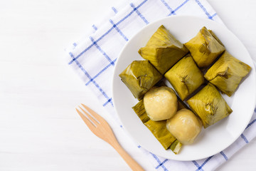 Thai dessert (Khanom Tian), sweet stuffed dough pyramid wrapped by banana leaf