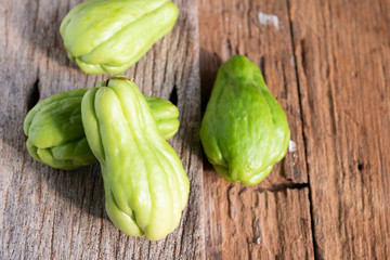 Fresh chayote fruits (Sechium edulis) on wood background
