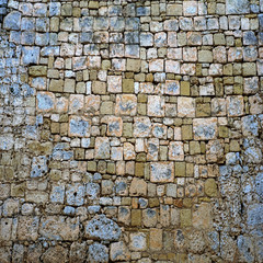 Old stone brick wall green and blue
