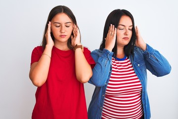 Young beautiful women wearing casual clothes standing over isolated white background with hand on headache because stress. Suffering migraine.