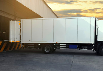 Cargo Container Trucks Parked Loading Dock at Distribution Warehouse. Shipping Trucks. Lorry. Cargo Freight Trucks Transport Logistics.