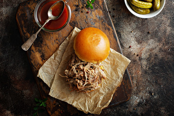 Pulled pork sandwich with brioche buns and pickles overhead view