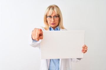 Naklejka premium Middle age scientist woman wearing glasses holding banner over isolated white background pointing with finger to the camera and to you, hand sign, positive and confident gesture from the front
