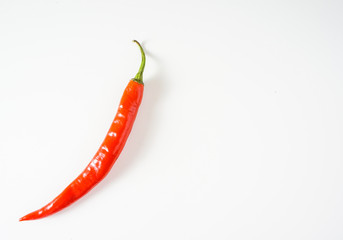 Top view of red hot chili pepper over white background.